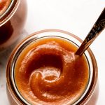 Close up of a swirl of apple butter in a jar.