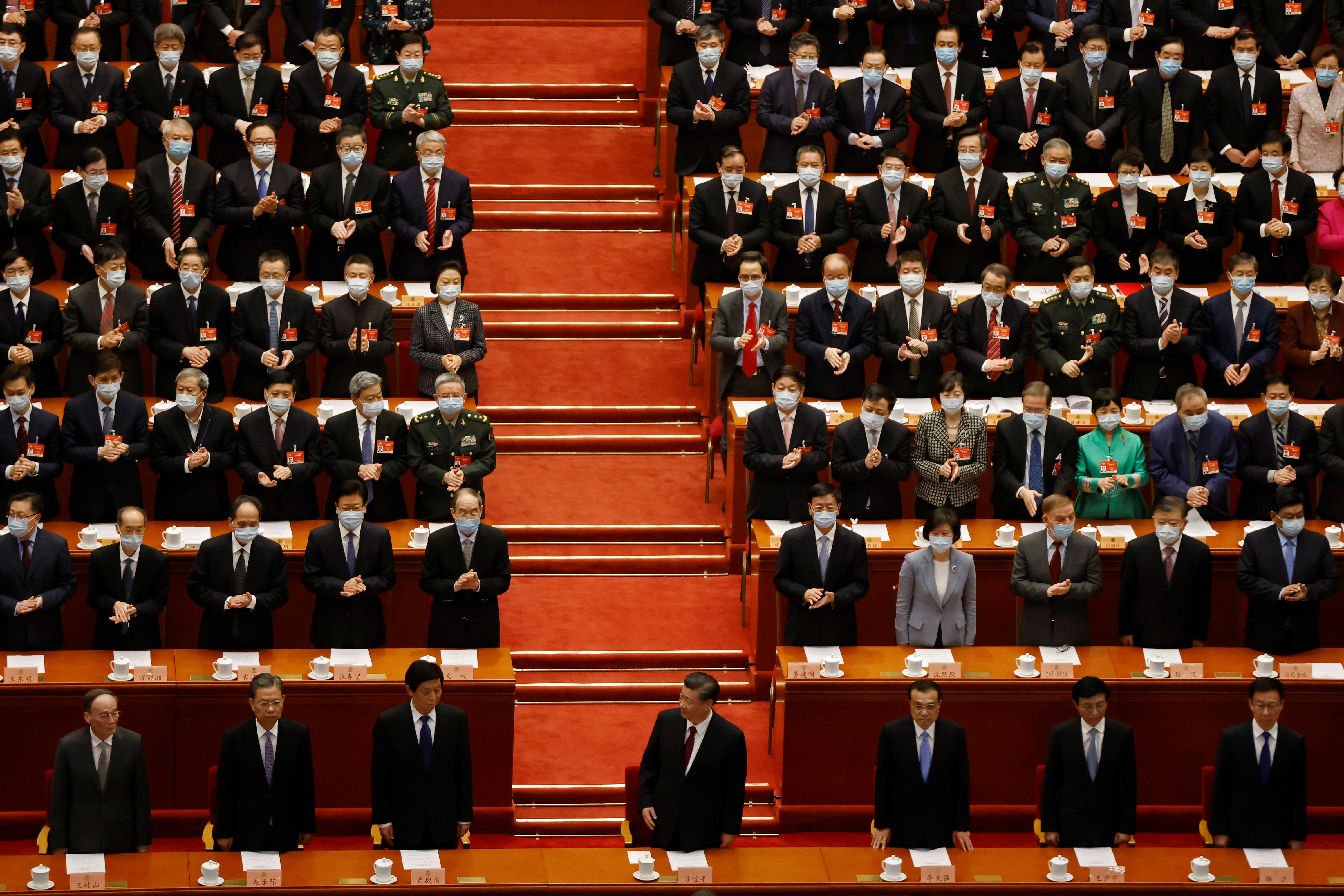 FILE PHOTO: Chinese President Xi Jinping (C), Vice President Wang Qishan, Politburo Standing Committee member Zhao Leji, National People's Congress (NPC) Standing Committee Chairman Li Zhanshu, Premier Li Keqiang, Politburo Standing Committee member Wang Huning and Vice Premier Han Zheng arrive for the closing session of the Chinese People's Political Consultative Conference (CPPCC) at the Great Hall of the People in Beijing, China March 10, 2021. REUTERS/Carlos Garcia Rawlins/File photo