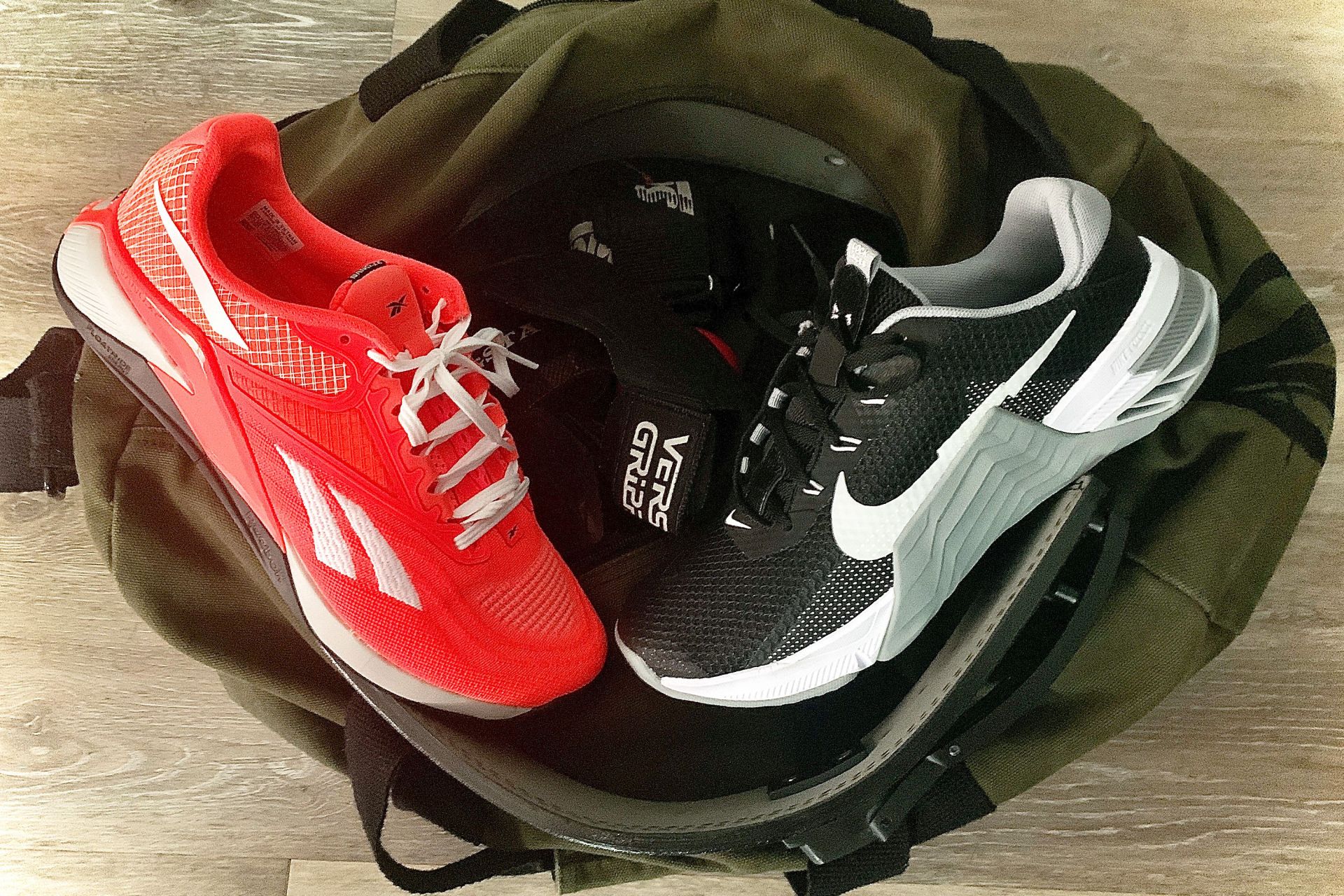 reebok nano x2 shoe and nike metcon 7 shoe sitting on top of a duffel bag