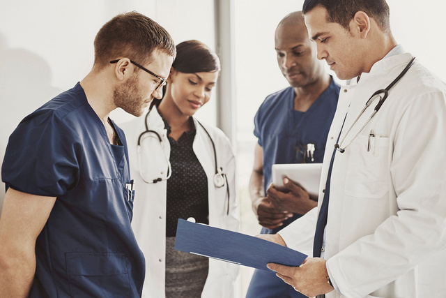 Doctors looking at a document