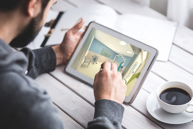 Man with a tablet and cup of coffee