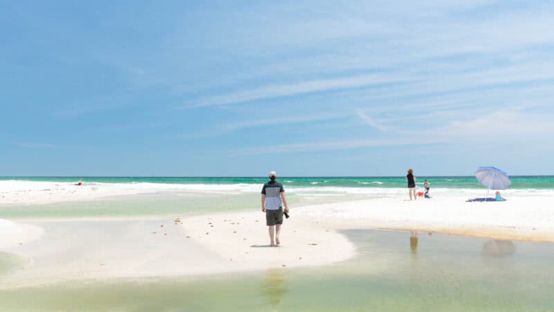 Man standing on a sand island at Camp St Helen State Park near Panama City Beach Florida - Top Tourist Attractions