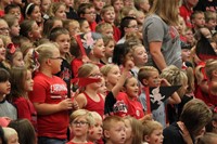 Elementary students in the stands at a pep rally