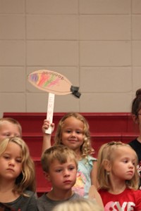 Elementary students in the stands at a pep rally