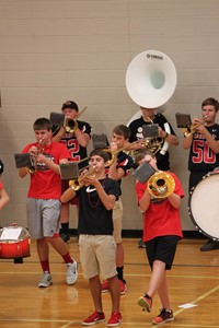 Students playing band instruments at pep rally