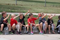 Students sitting on curb waiting for parade