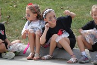 Students sitting on curb waiting for parade