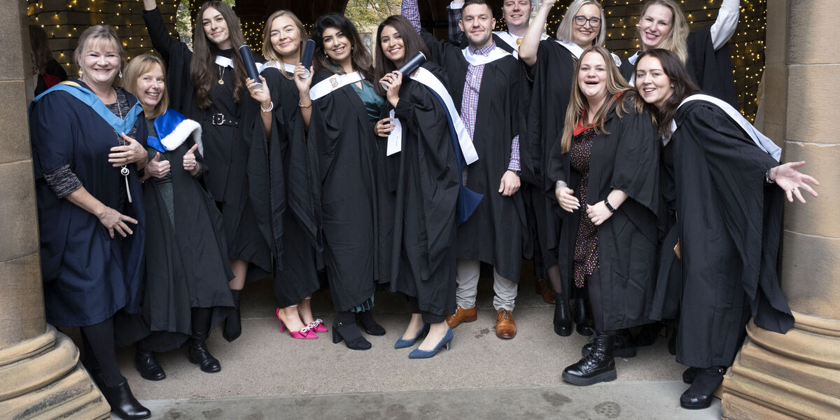 Class of graduates with scroll