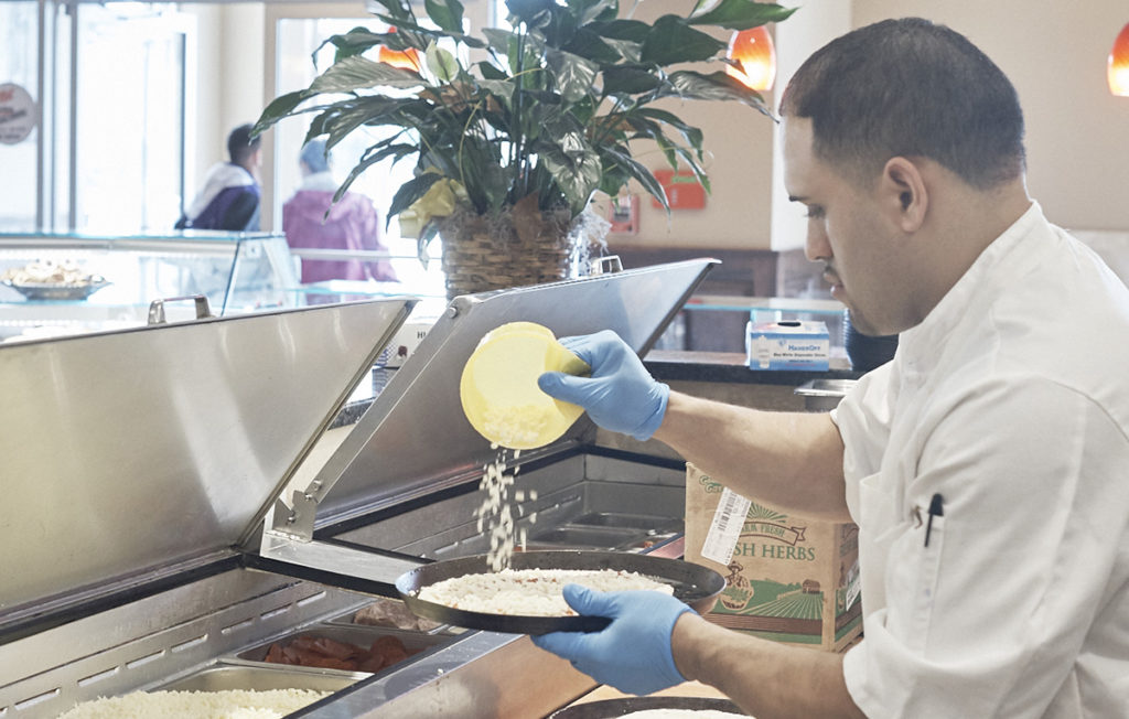 Pizza maker using Grande diced mozzarella and portion cups