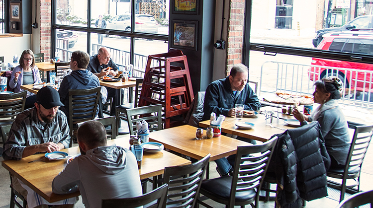 Customers dining at local pizzeria