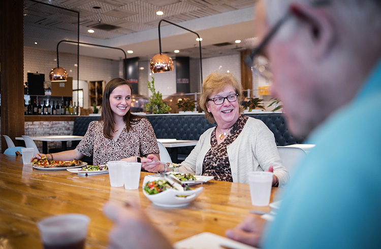 Family enjoying pizza at a modern pizzeria