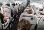 Interior of commercial airplane with passengers in their seats