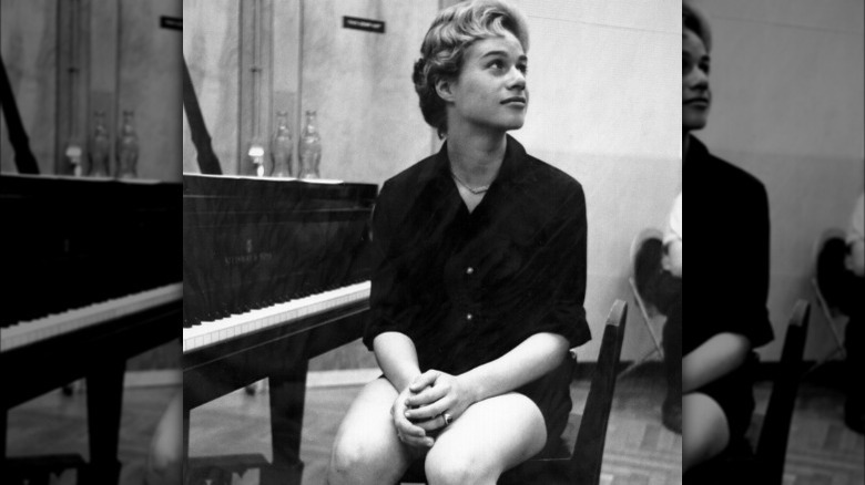 Carole King sitting at a piano