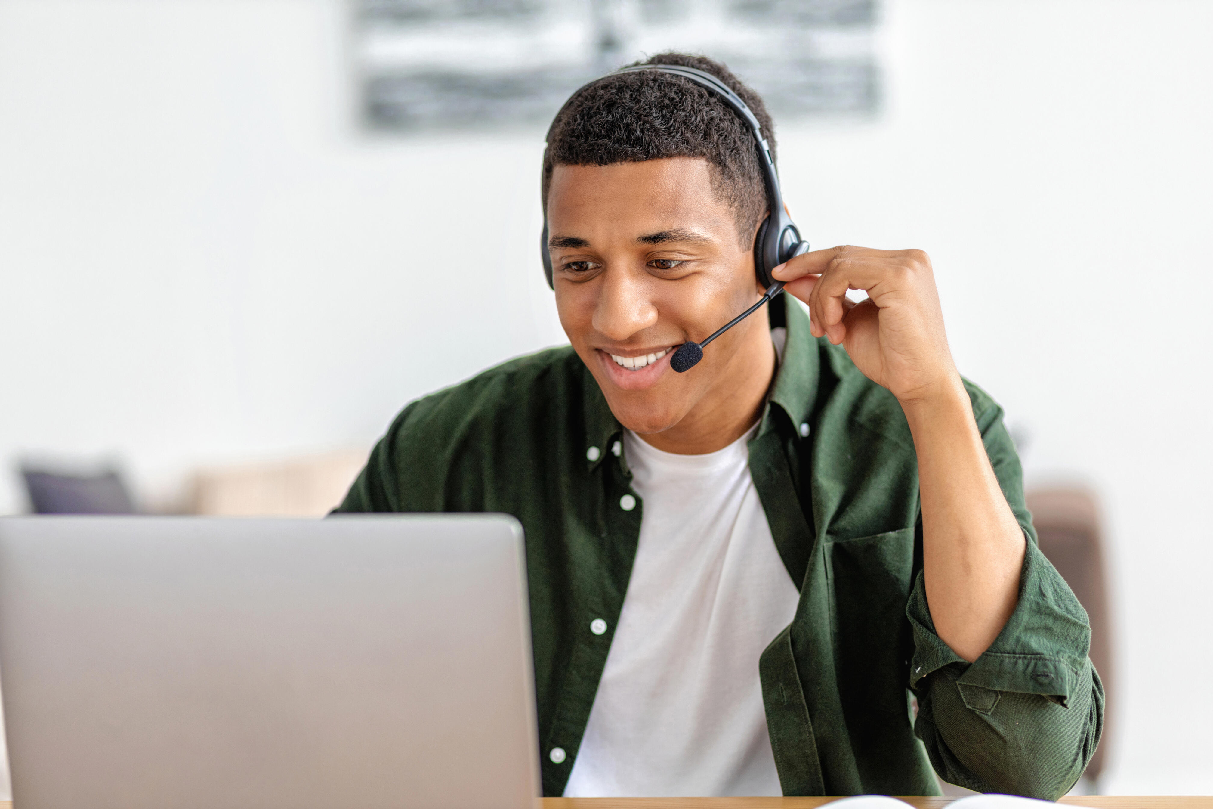 man with headset using laptop