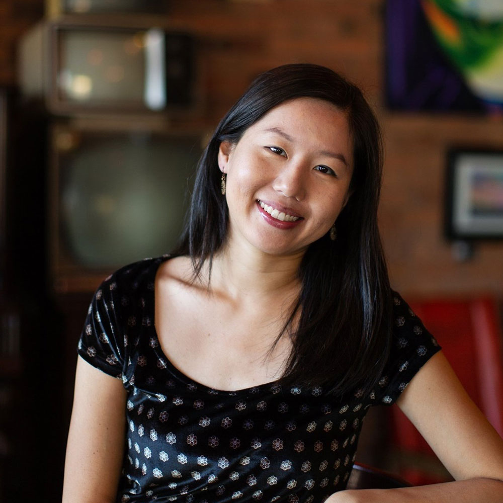 Photograph of a woman with long black hair and fair skin smiling