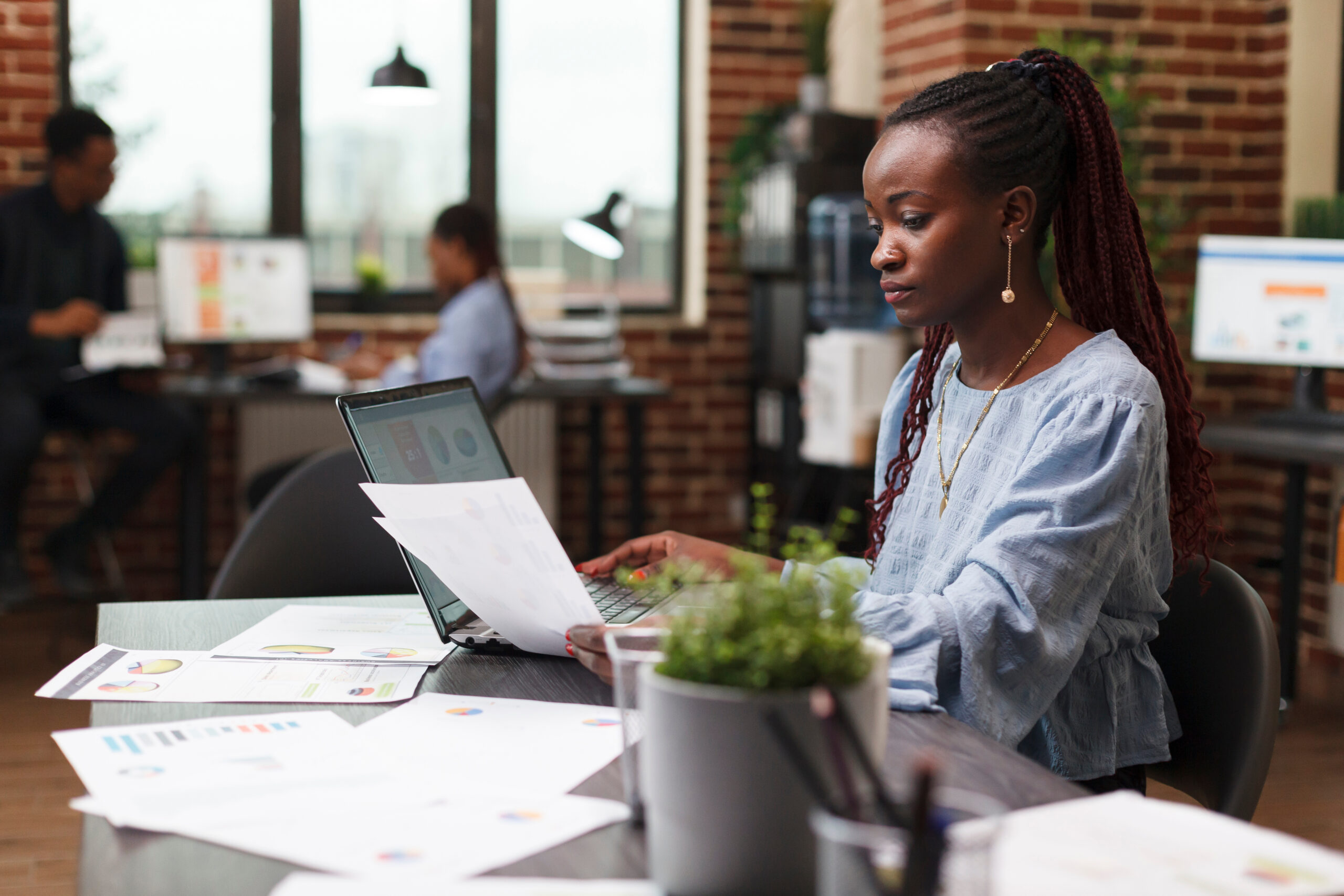 Financial company business advisor looking over accounting paperwork while analyzing potential finance risks. Marketing agency office person having management documentation while sitting at desk.