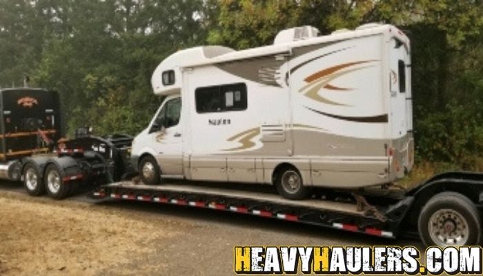 Transporting a Davion motorhome on a trailer.