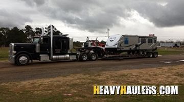 Hauling a motorhome on a lowboy trailer.