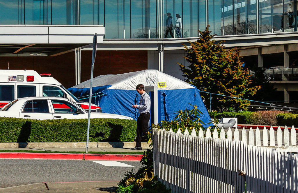 A tent has been set up outside Providence Regional Medical Center Everett’s Colby Campus to screen people for symptoms of possible coronavirus before they enter the hospital. (Dan Bates / The Herald)
