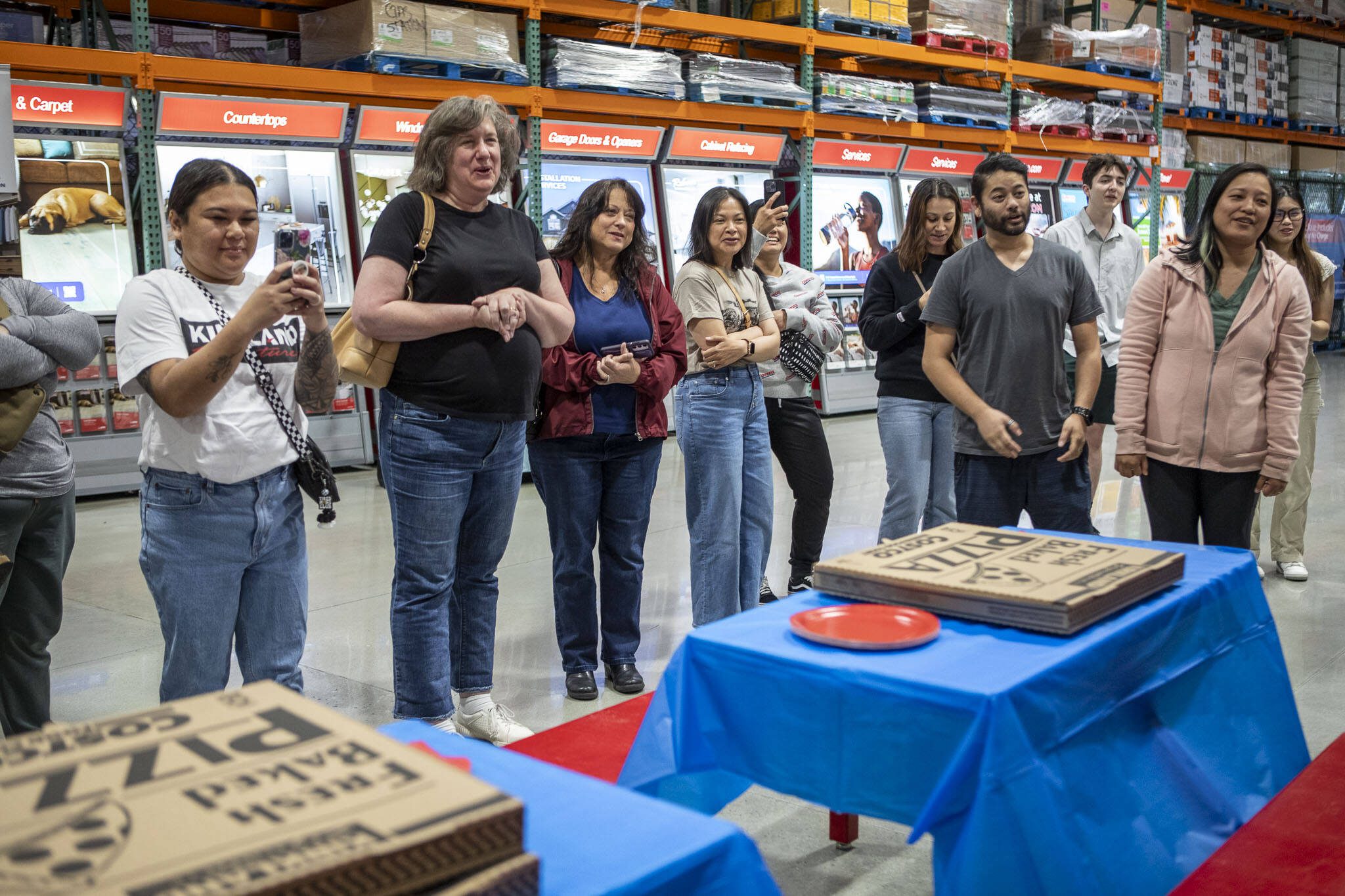 Friends and family sing “Happy Birthday” during a first birthday party at Costco in Lake Stevens on Friday, May 31, 2024. (Annie Barker / The Herald)