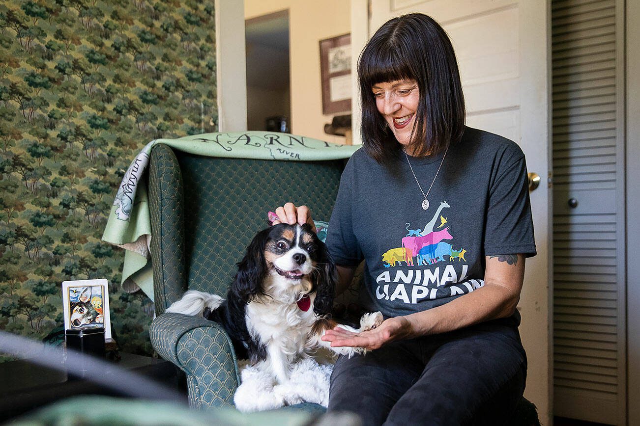 Animal Chaplain Shel Graves has her dog Lily pose for a photo in her home office on Tuesday, July 9, 2024 in Everett, Washington. (Olivia Vanni / The Herald)