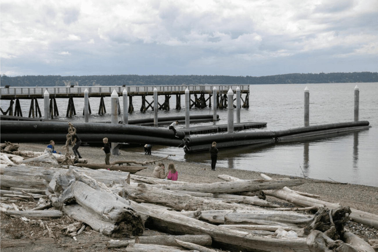 Children fish in the water and climb near the renovated boat launch at Kayak Point Regional County Park on Friday, June 14, 2024, near Stanwood, Washington. (Ryan Berry / The Herald)