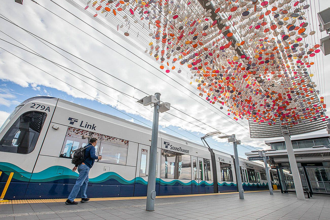 A person walks past Laura Haddad’s “Cloud” sculpture before boarding a Link car on Monday, Oct. 14, 2024 in SeaTac, Washington. (Olivia Vanni / The Herald)