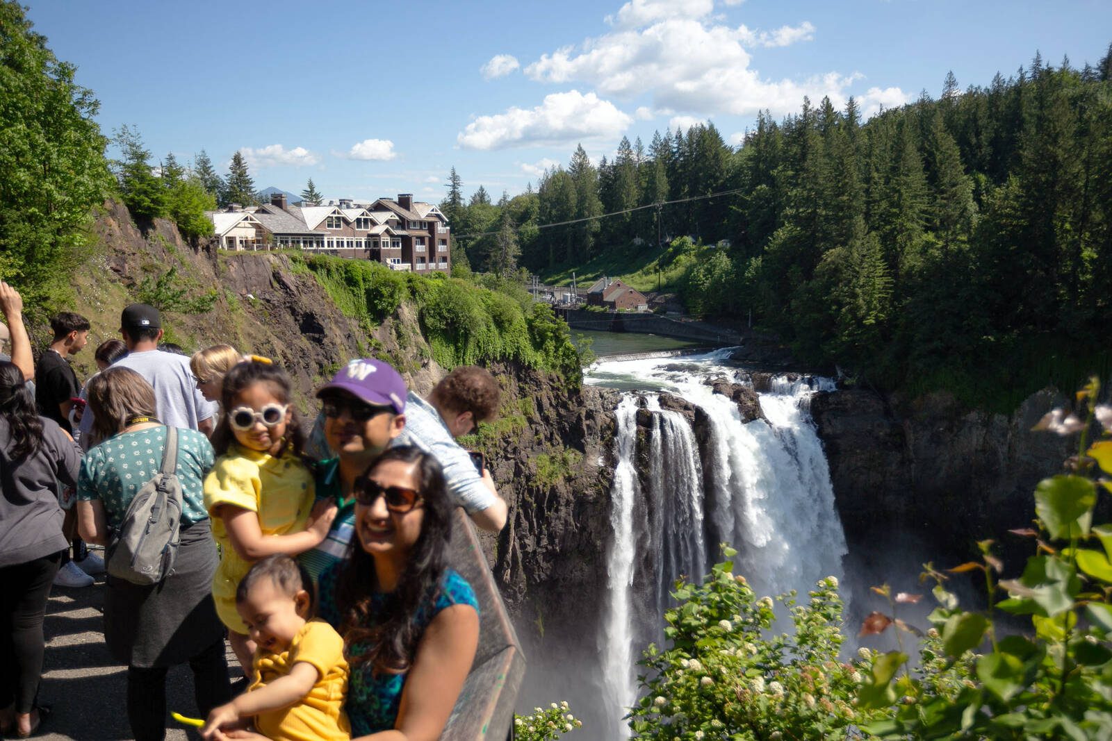 Tourists crowd the Snoqualmie Falls viewpoint to get photos of the falls and the adjacent Salish Lodge & Spa, in Snoqualmie, Washington. Ryan Berry / The Herald