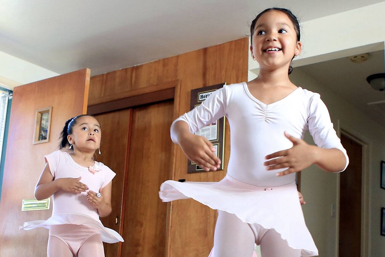 Devani Padron, left, Daisy Ramos perform during dance class at Mari's Place Monday afternoon in Everett on July 13, 2016. (Kevin Clark / The Herald)