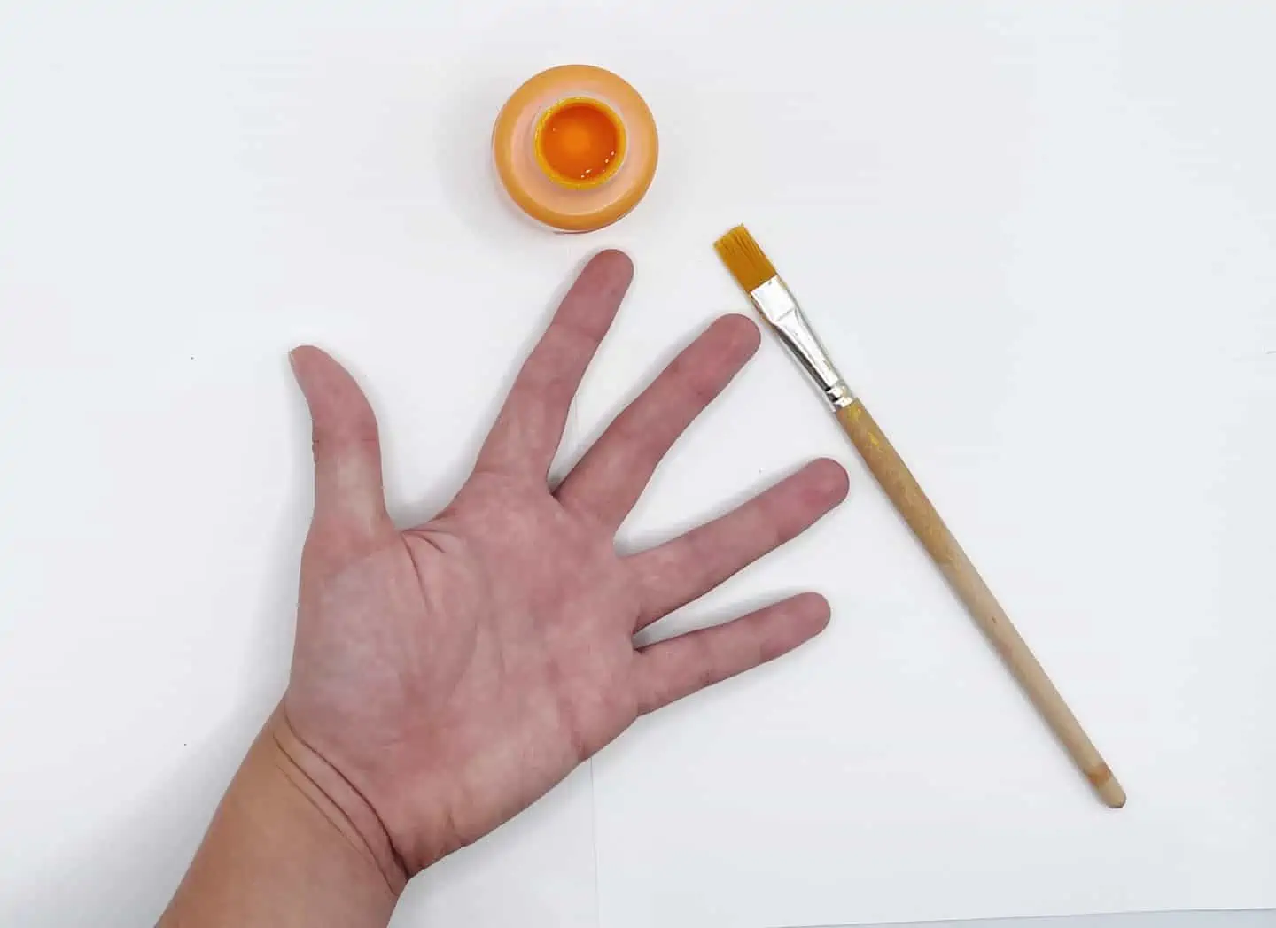 hand and orange paint