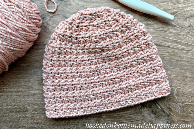 The Grid Beanie Crochet Pattern uses basic crochet stitches to create a subtle waffle or grid-like texture.