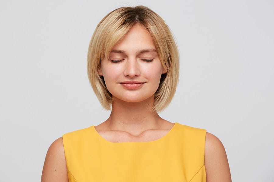 woman with layered blonde bob cut