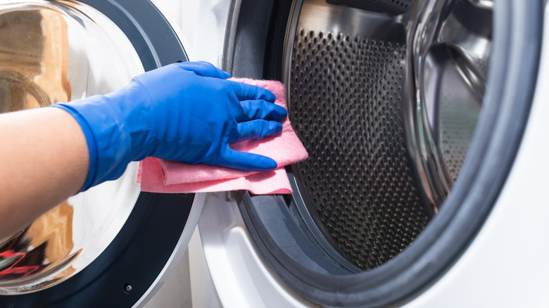 Hand wiping washing machine door