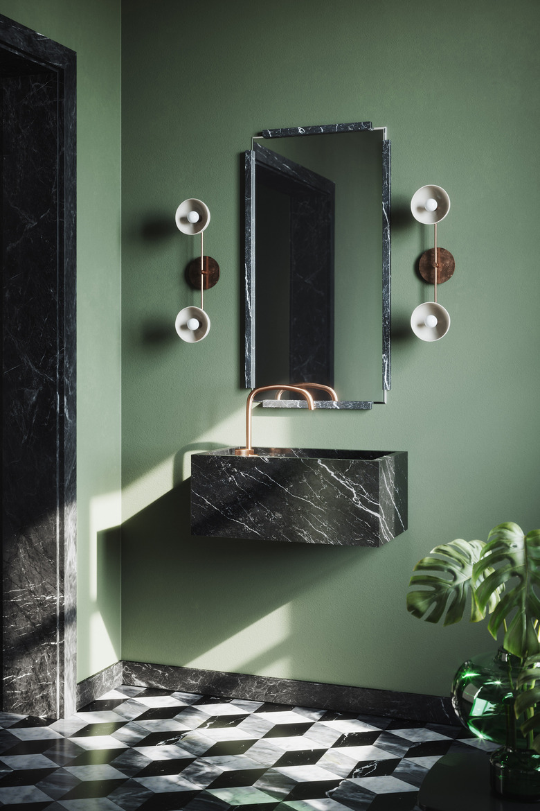 floating black marble bathroom sink in sage green bathroom