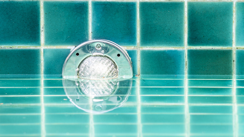 Light installation on swimming pool wall