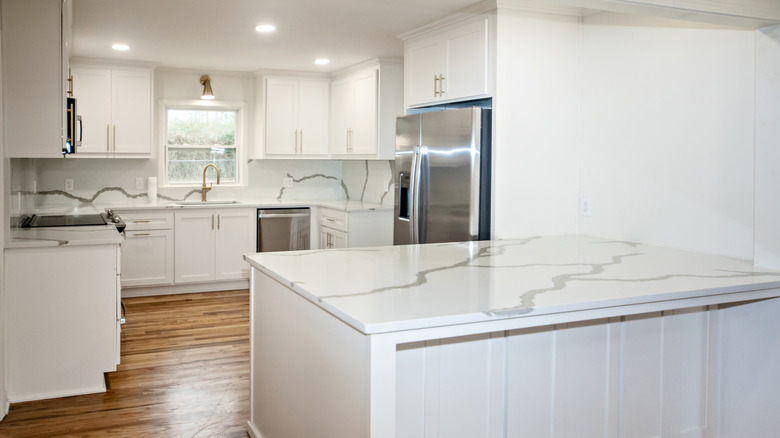 all white kitchen with wood floor