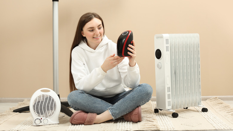 Woman with many space heaters