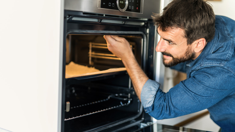 Man repairing an oven