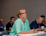 A participant concentrates at an education session