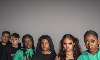 Six teenagers wearing Virgil Abloh ICA clothing stare directly at the camera in front of a neutral background.