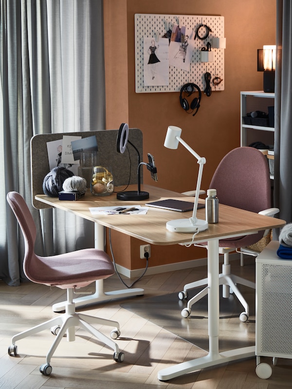 A workspace centred around a BEKANT desk and a HATTEFJÄLL office chair in a softly sunlit room with an earthy colour palette.