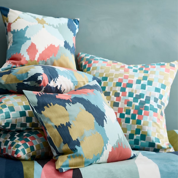 Colorful pillows with pastel-colored designs on them.