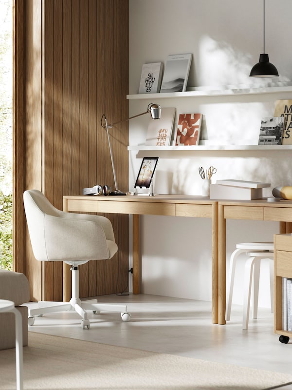 A home office with an oak veneer TONSTAD desk and a white office chair.