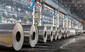 Large rolls of aluminum sheets in a warehouse facility. The rolls are lined up using proper storage standards.