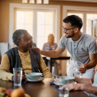 caregiver assist his patient in eating