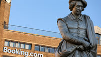 Booking.com HQ headquarters head office building on the Rembrandtplein Rembrandt Square with the statue of Rembrandt. Amsterdam.