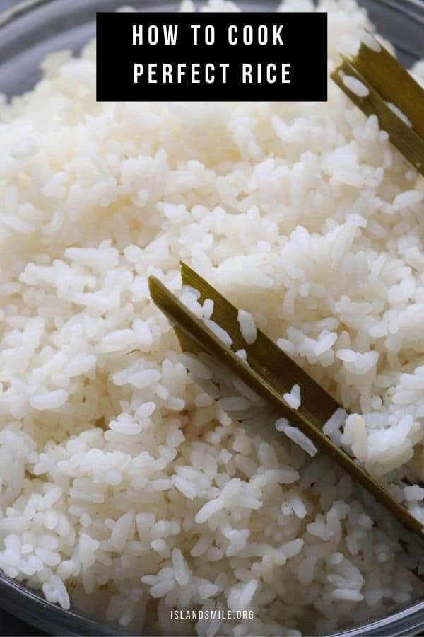 cooking rice over the stove top with pandan leaves.