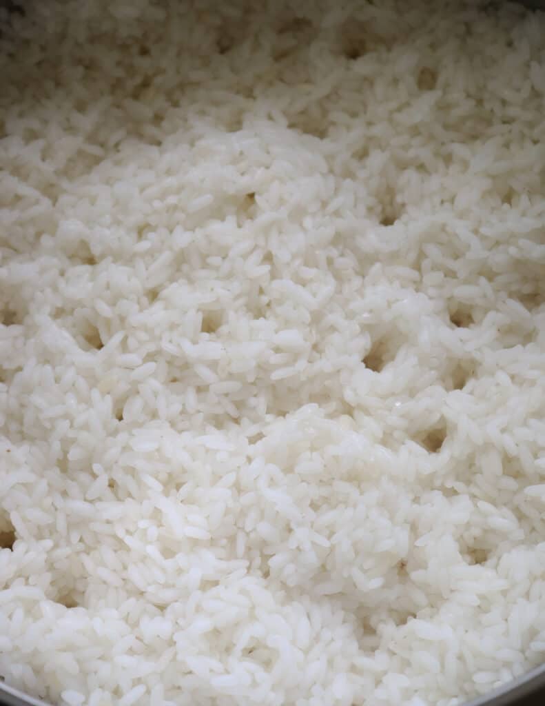 cooking rice over a stove top at the last stage.