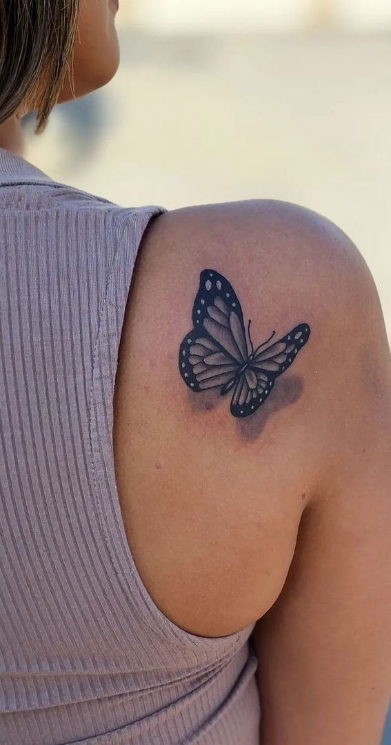 Fine line butterfly tattoo located on the shoulder