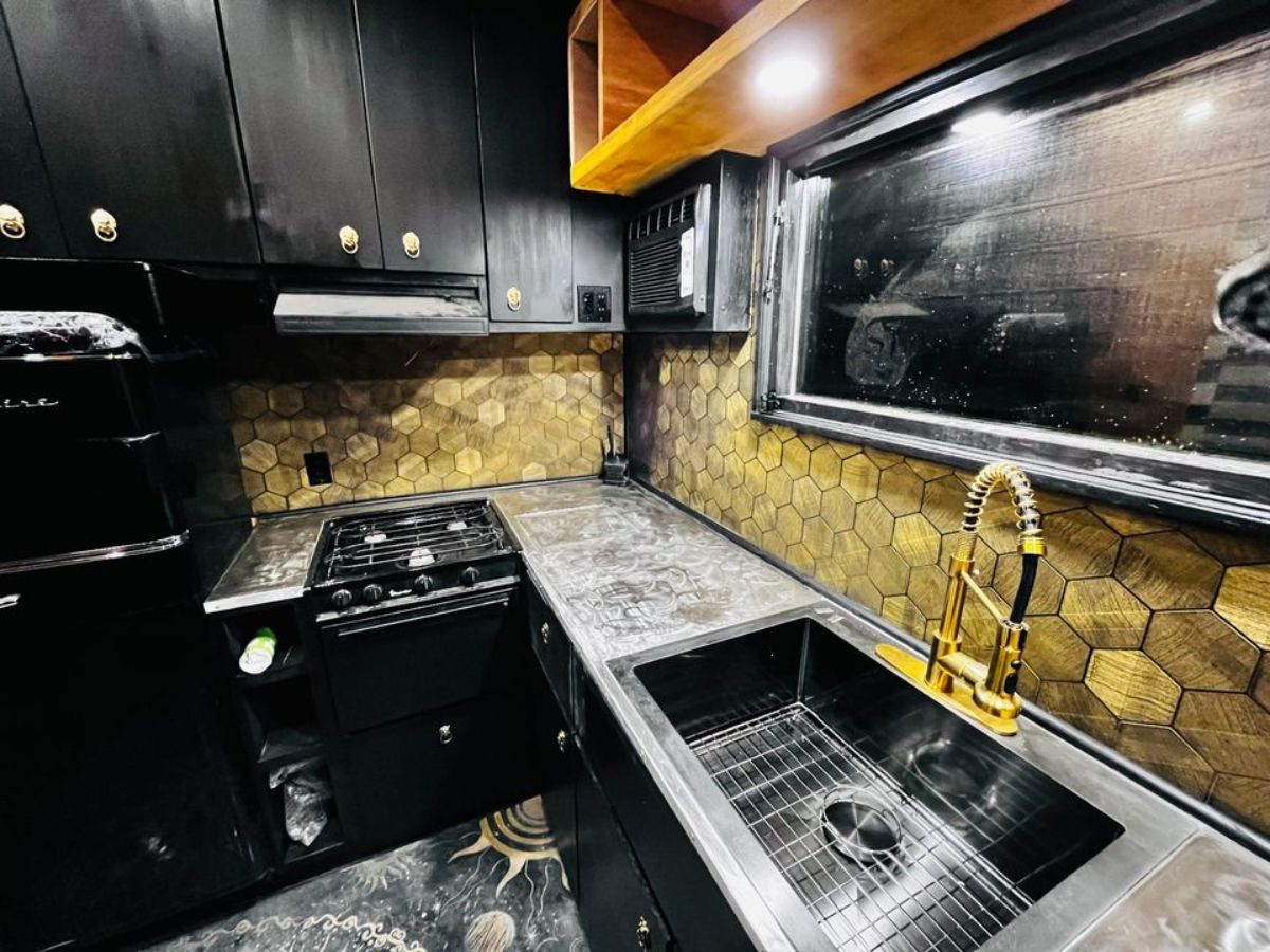 stainless steel sink with gas stove in kitchen 